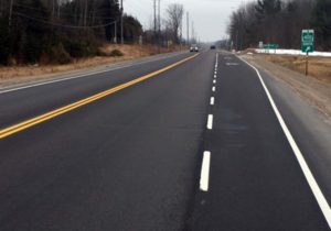 Cars driving on freshly paved and painted highway 12